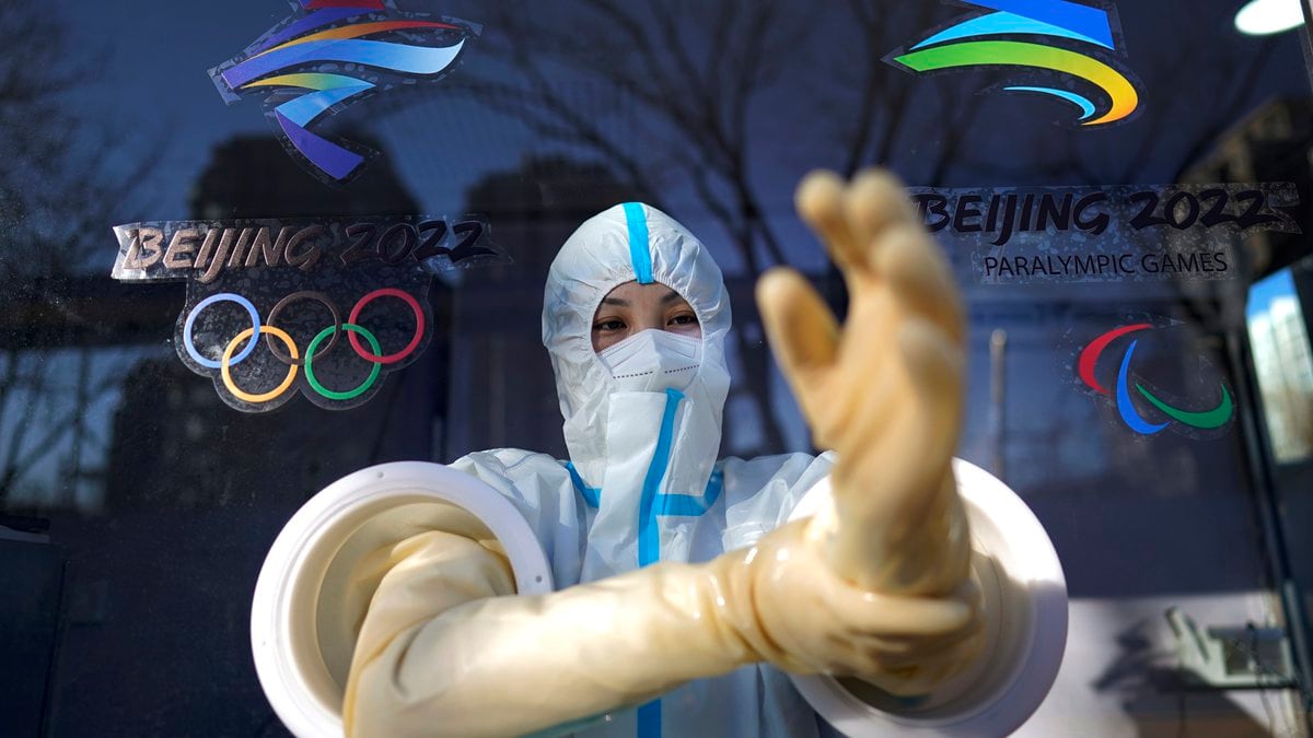A worker prepares to administer a COVID-19 test at the 2022 Winter Olympics, Tuesday, Feb. 1,...