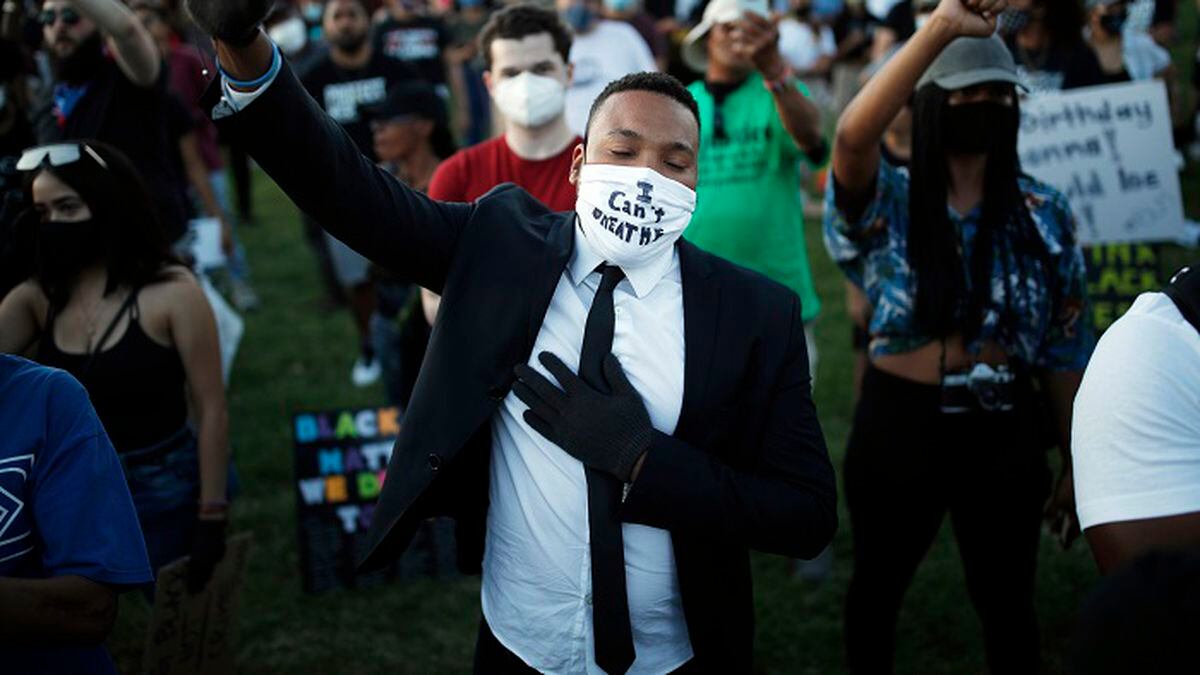 People raise their fists during a rally, Friday, June 5, 2020, in Las Vegas, against police brutality sparked by the death of George Floyd, a black man who died after being restrained by Minneapolis police officers on May 25. (Source: AP Photo/John Locher)