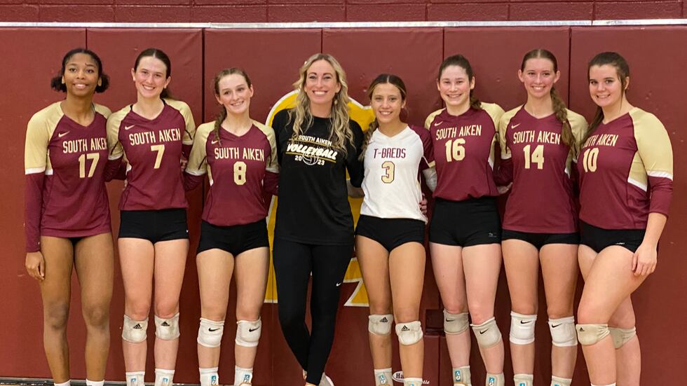 Head Coach Cassie Mckie and senior teammates