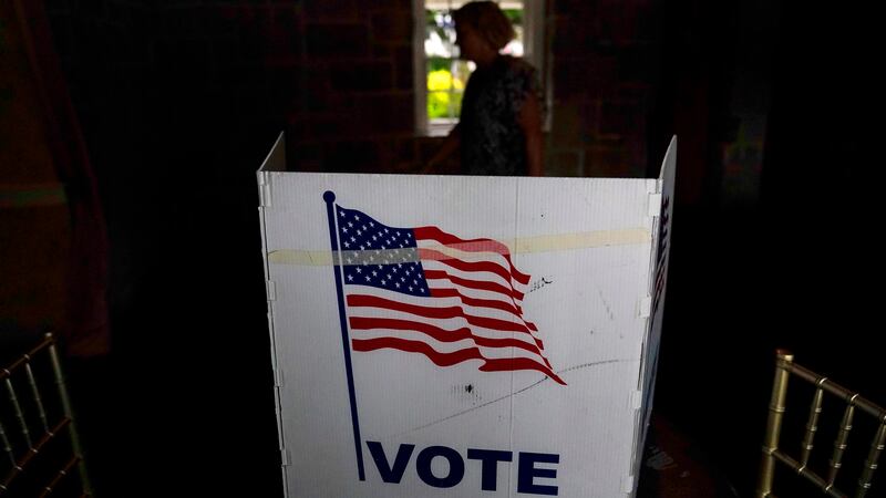 FILE - A person waits in line to vote in the Georgia's primary election on May 24, 2022, in...