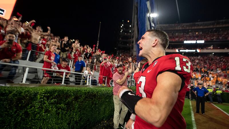 Georgia quarterback Stetson Bennett (13) reacts to the crowd as he leaves the field following...