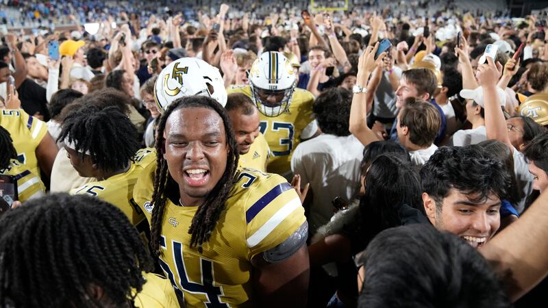 Georgia Tech fans swam the field after defeating North Carolina in an NCAA college football...