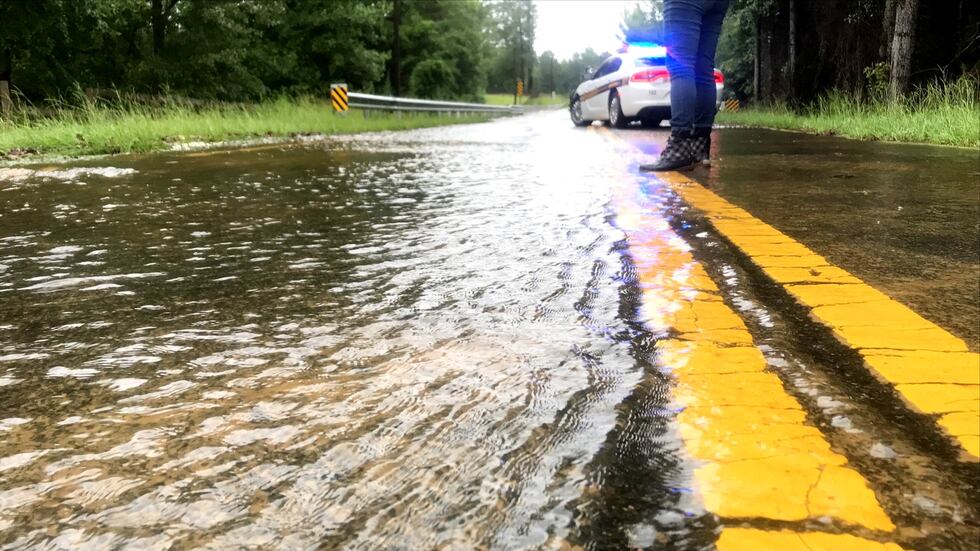 Water covers Old Shoals Road on Tuesday morning after flooding closed a bridge near Monetta.