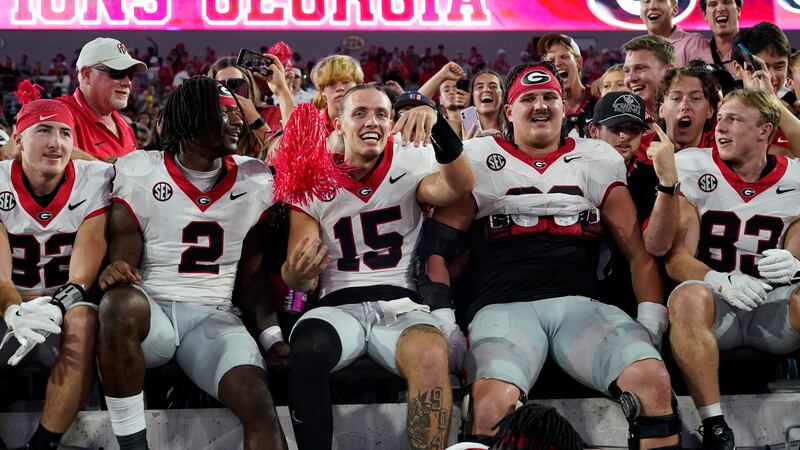 Georgia quarterback Carson Beck (15) celebrates with teammates and fans after defeating...