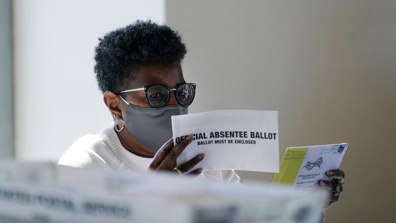 A worker at the Fulton County Board of Registration and Elections works to process absentee...