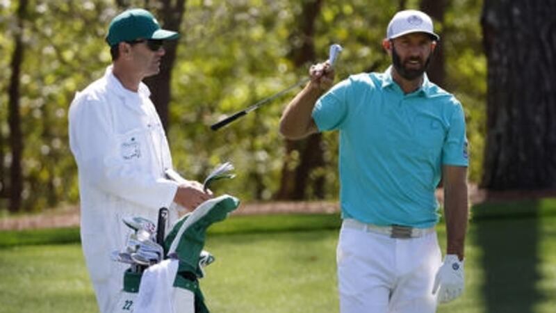 Masters champion Dustin Johnson prepares to play a stroke on No. 11 during practice round 1...
